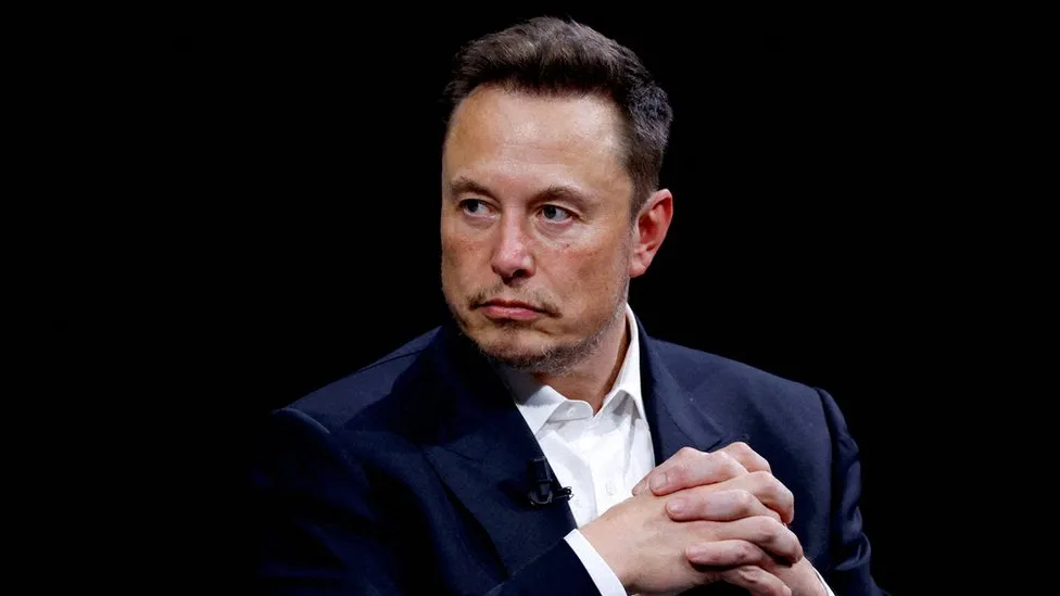 Tesla: Electric carmaker’s shares slide after Musk warns of slowdown